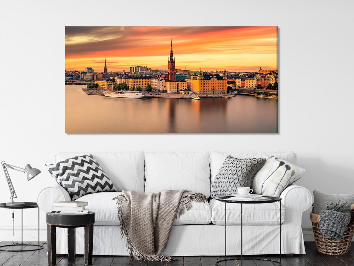 Warm sunset cityscape skyline with spired towers and reflections in calm water detail view