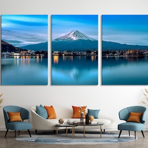 May include: A three-panel canvas print featuring a scenic view of Mount Fuji reflected in a still lake. The mountain is snow-capped and the lake is a deep blue color. The print is perfect for adding a touch of nature to any room.