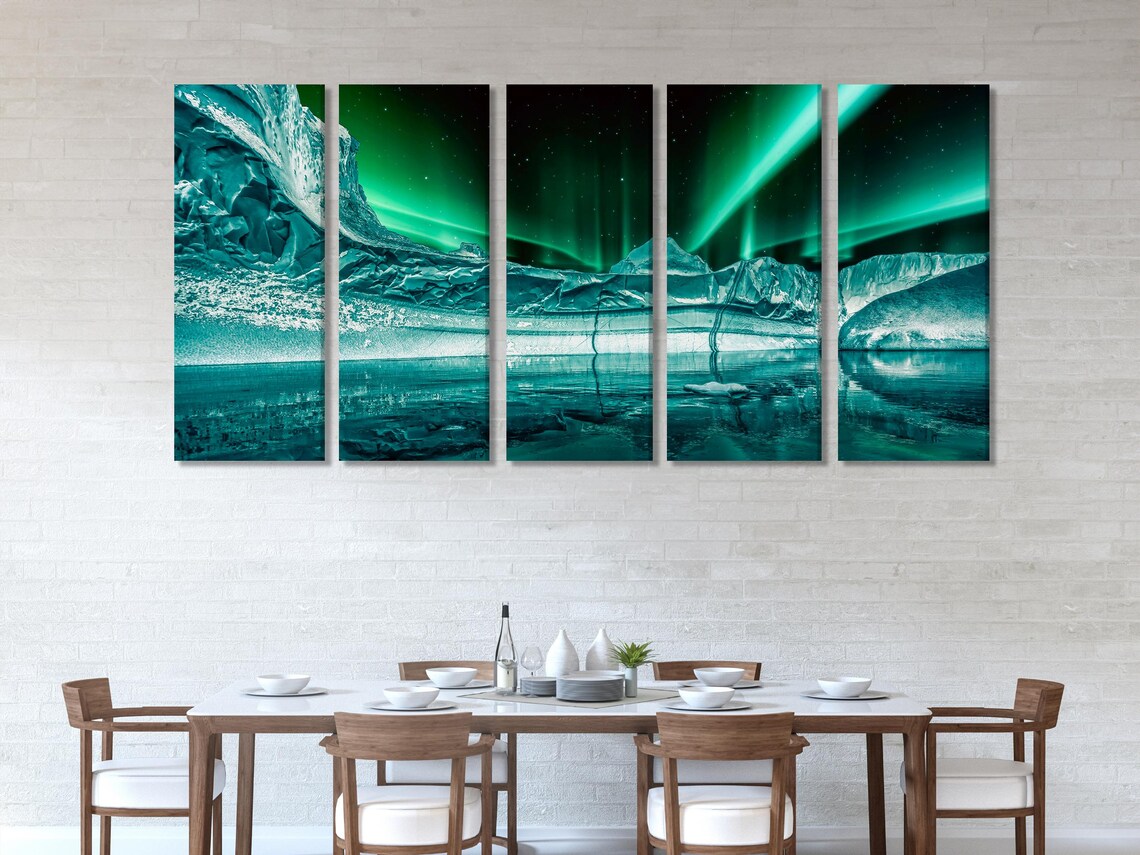 Mockup room with three teal-green northern lights artworks above a sofa