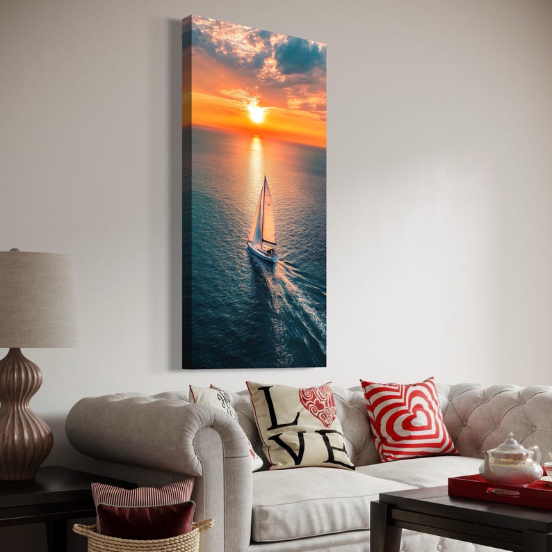 Lone sailboat on ocean water at sunset with bright sun, clouds, and golden reflections