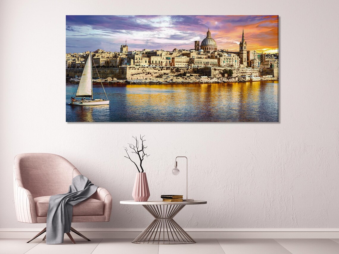 Living room mockup with a wall of five-panel sunset harbour cityscape artwork above a green sofa