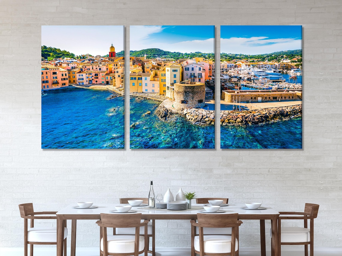 Room mockup showing a large harbour town artwork above a sofa