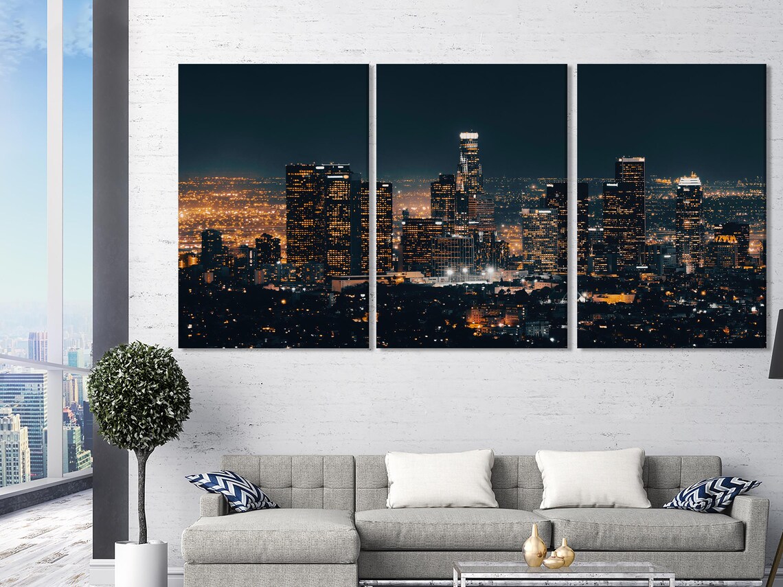 Living room mockup with a framed night city skyline artwork above a sofa