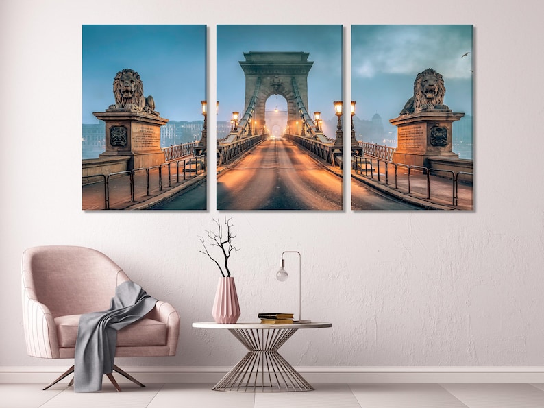Three-panel misty bridge cityscape at dusk with warm lamps and lion sculptures on pillars