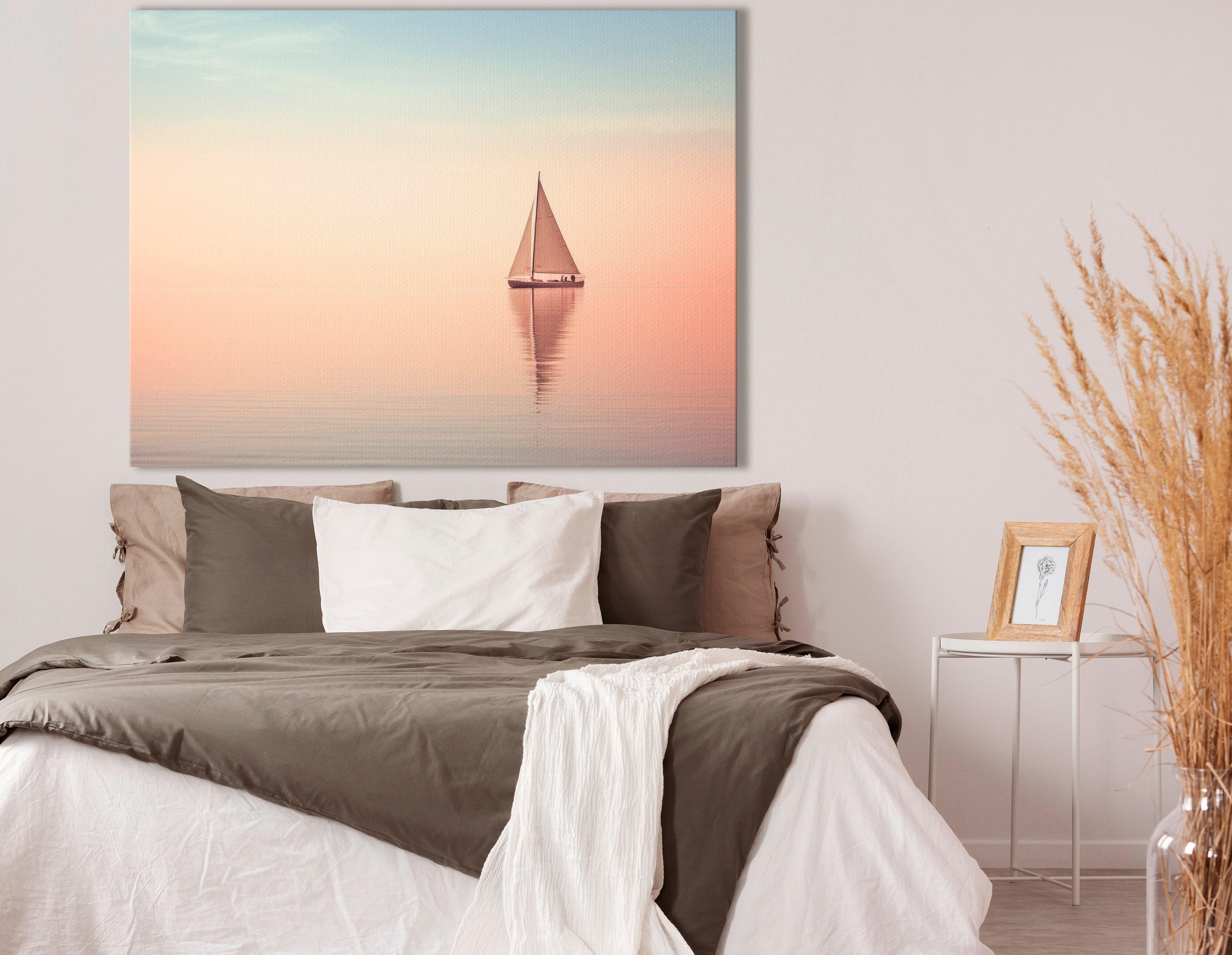Bedroom scene with a framed pastel sailboat seascape above a bed