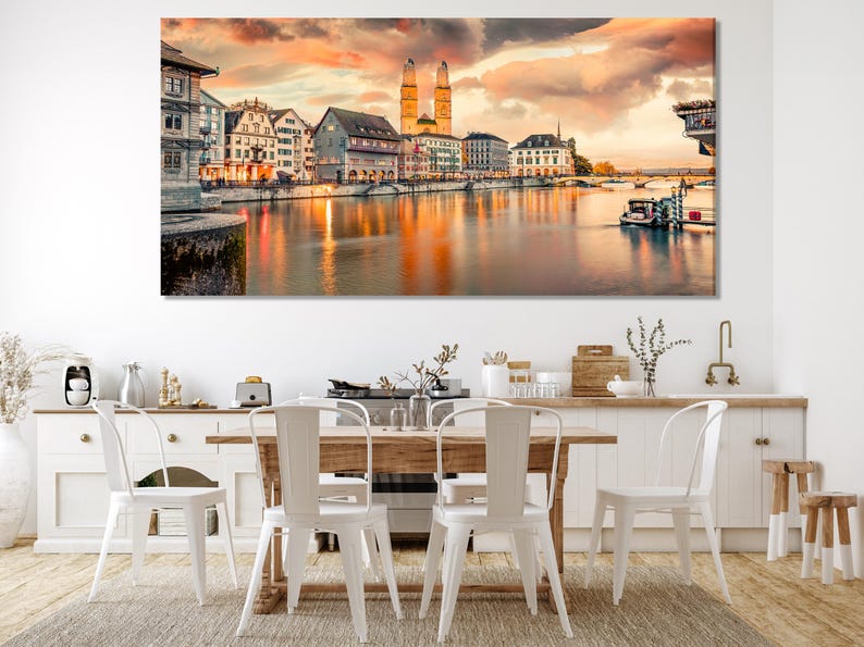Sunset cityscape with church towers reflected in calm river water