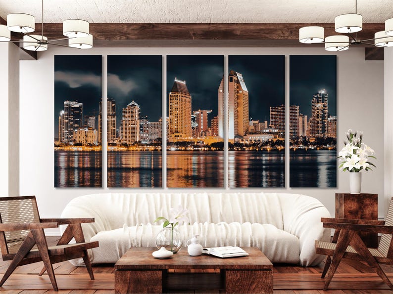Night city skyline with illuminated buildings and gold reflections on dark water