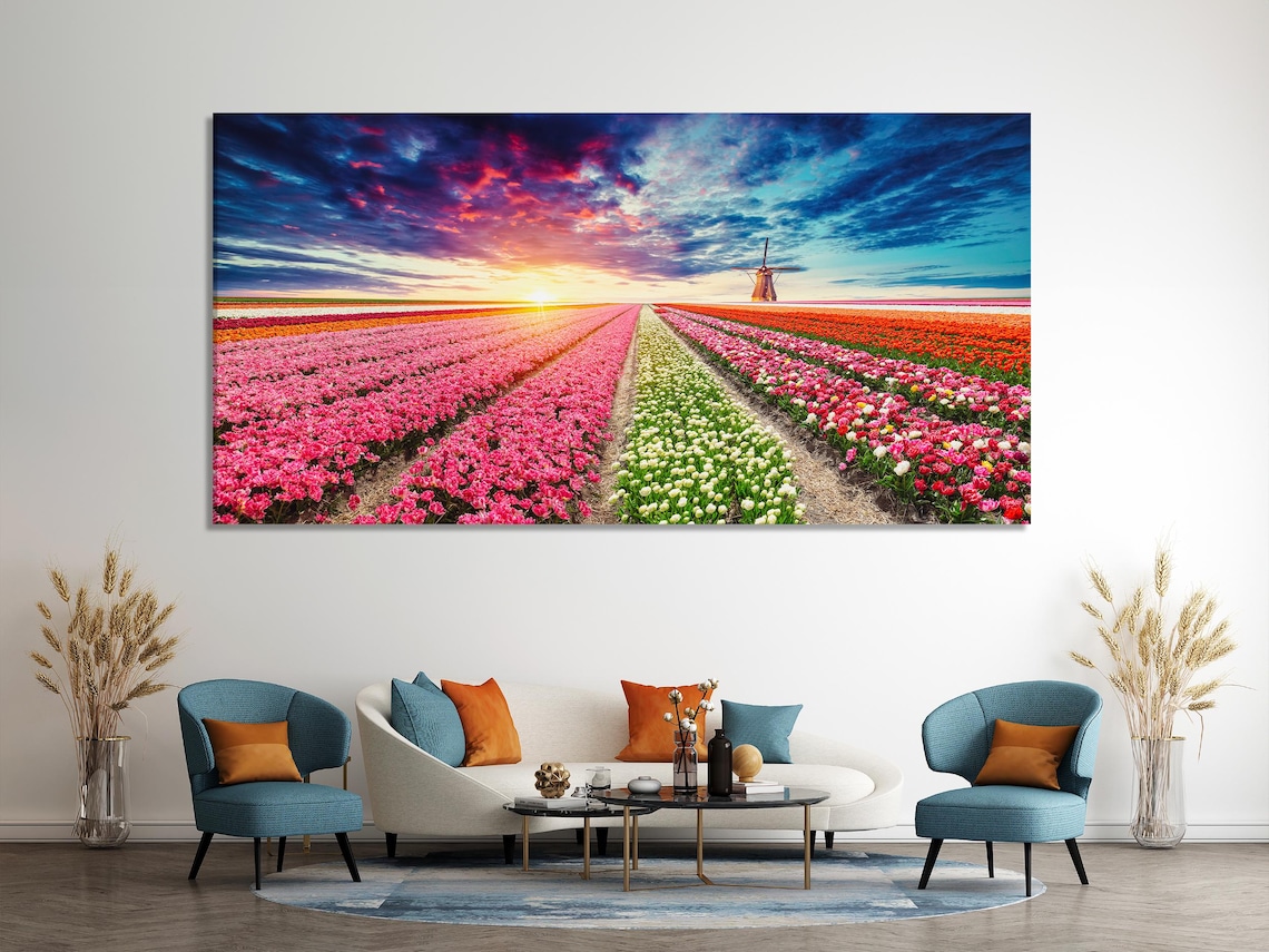 Room mockup with three panels of tulip field landscape wall art above a blue sofa