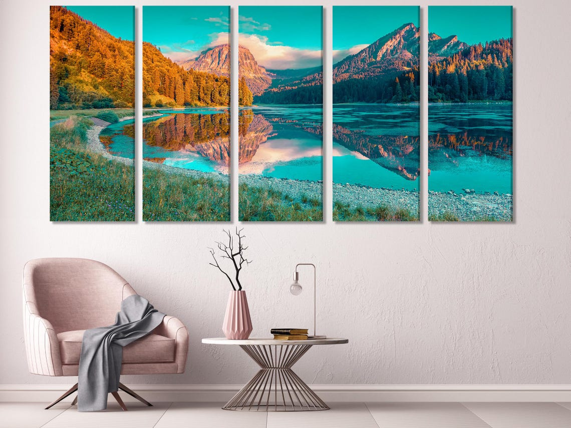 Mountain lake artwork above a sofa in a modern room