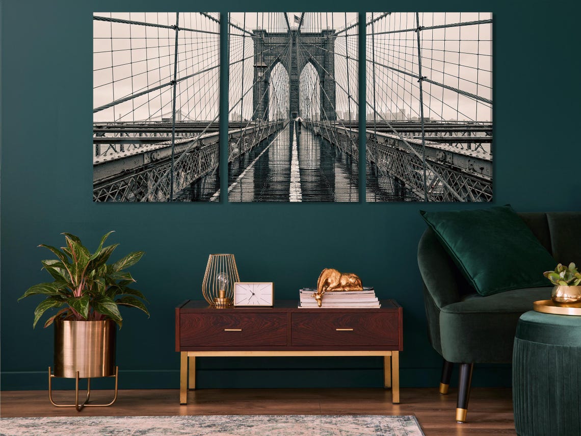 Room mockup showing a black-and-white bridge artwork above a green sofa
