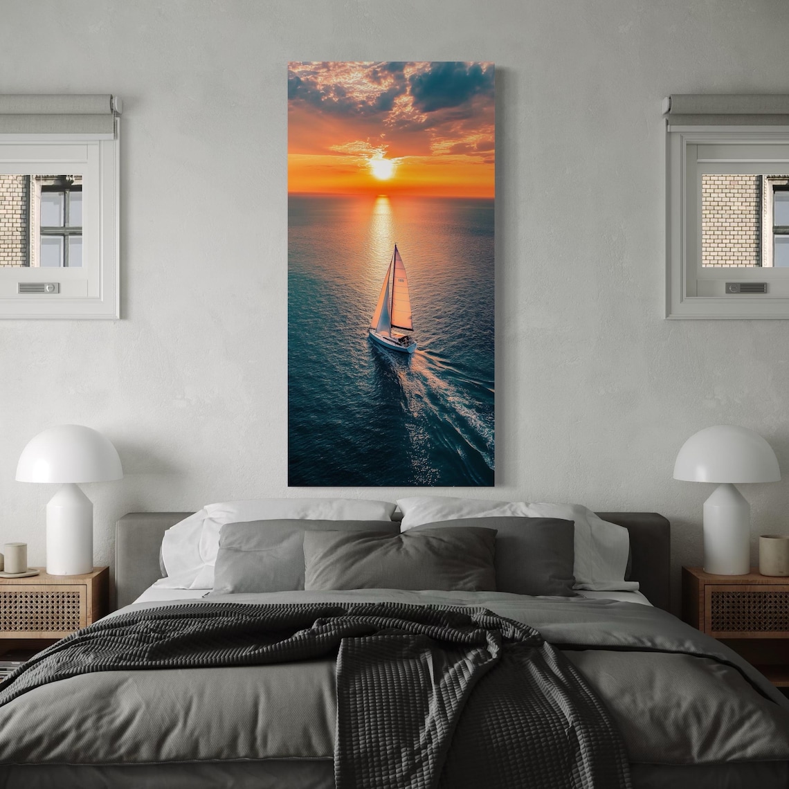 Lone sailboat on ocean water at sunset with bright sun, clouds, and golden reflections detail view