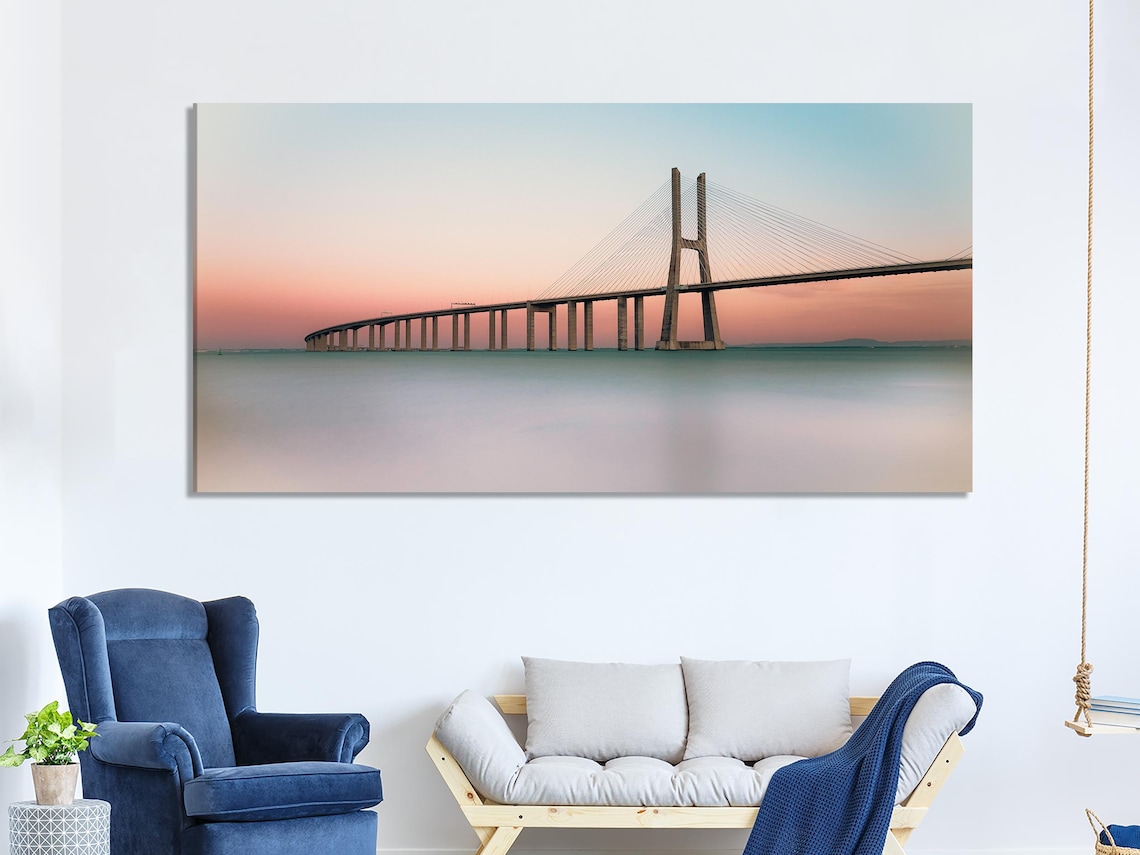 Room mockup showing three panels of sunset bridge artwork above a console