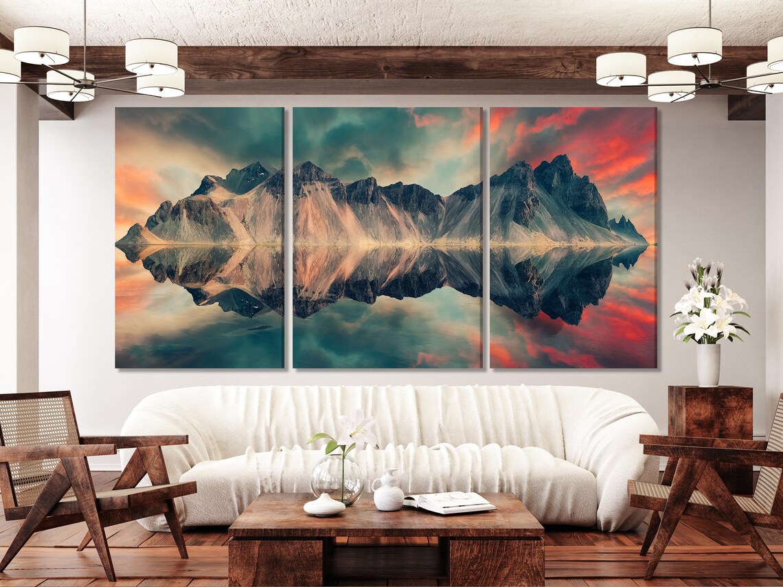 Wall mockup showing a split mountain sunset artwork above a sofa in a bright room