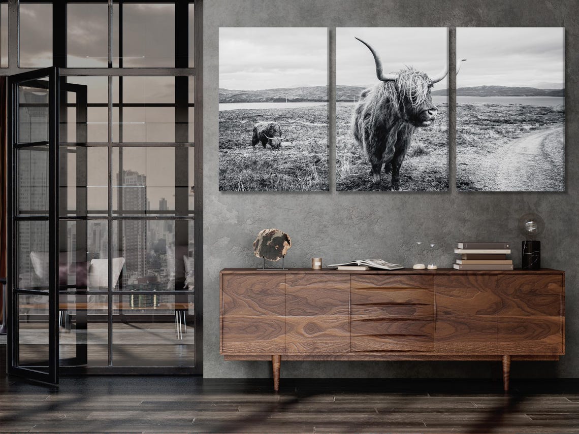 Room mockup showing a black and white Highland cow artwork above a sofa
