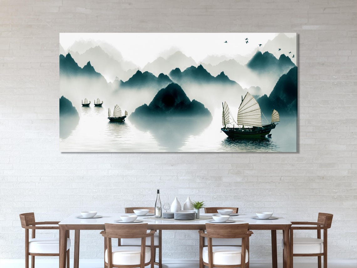 Misty mountain landscape in grey and teal tones with calm water reflections and small sailing boats detail view