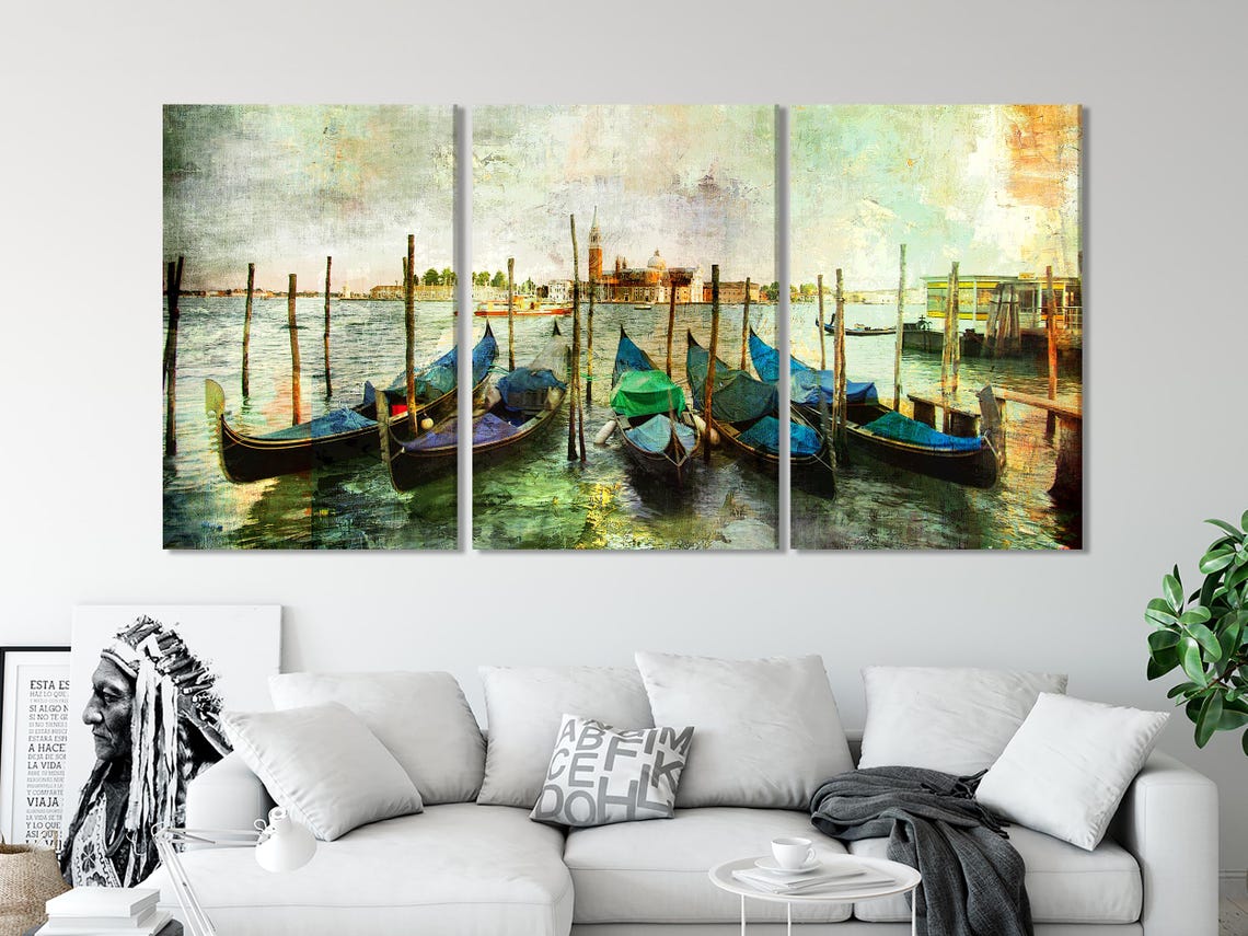 Colourful Venice gondolas moored at wooden posts with teal boat covers and rippled water reflections detail view