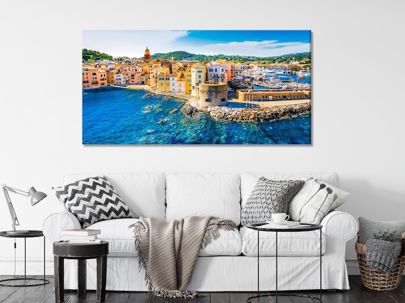 Vivid coastal town harbour scene with colourful buildings and turquoise-blue sea