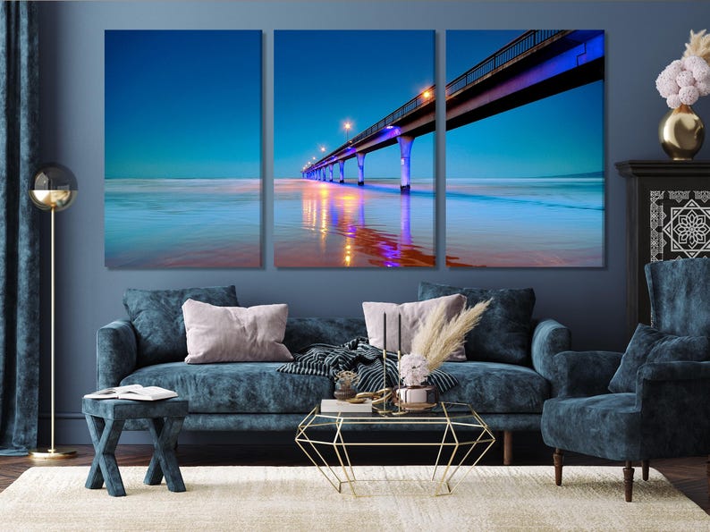 Three-panel night seascape showing an illuminated pier and glowing reflections on calm ocean water