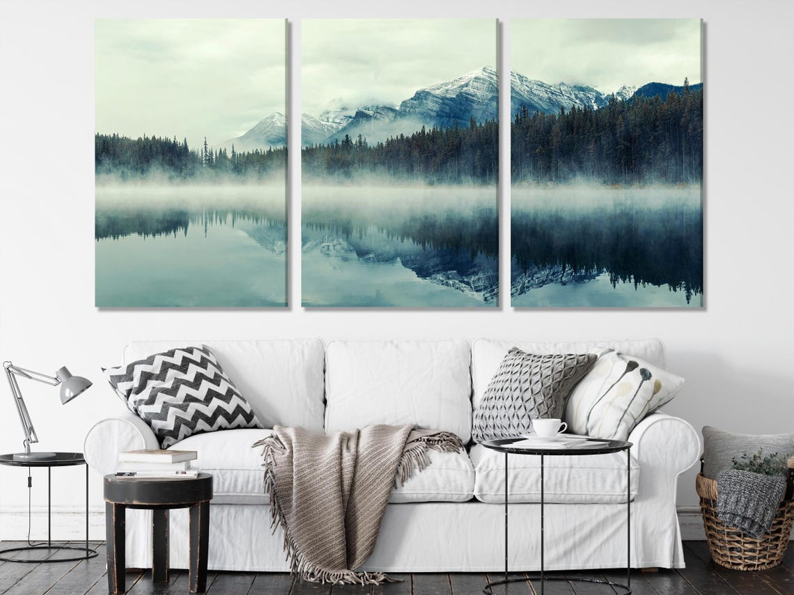 Room mockup showing a misty mountain lake artwork above a sofa