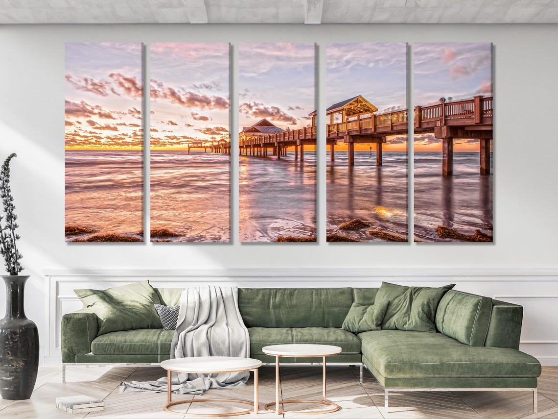Room mockup showing a sunset ocean pier artwork above a dining table