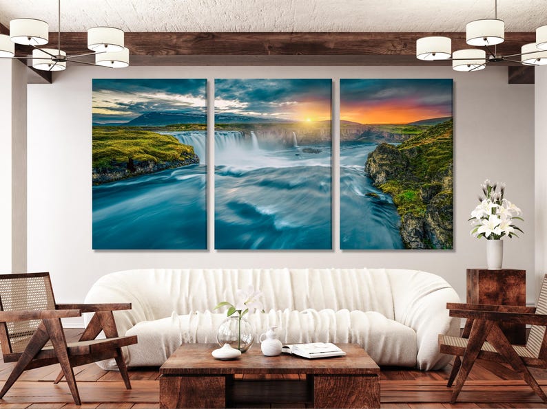 Three-panel waterfall landscape with rocky cliffs, green hills and sunset glow in cool teal and blue
