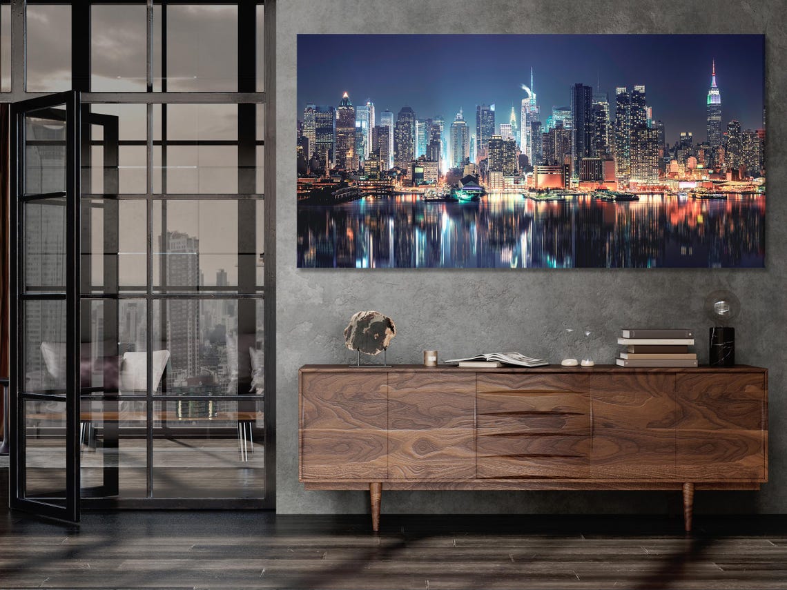 Room mockup showing a set of vertical night skyline artworks above a sofa