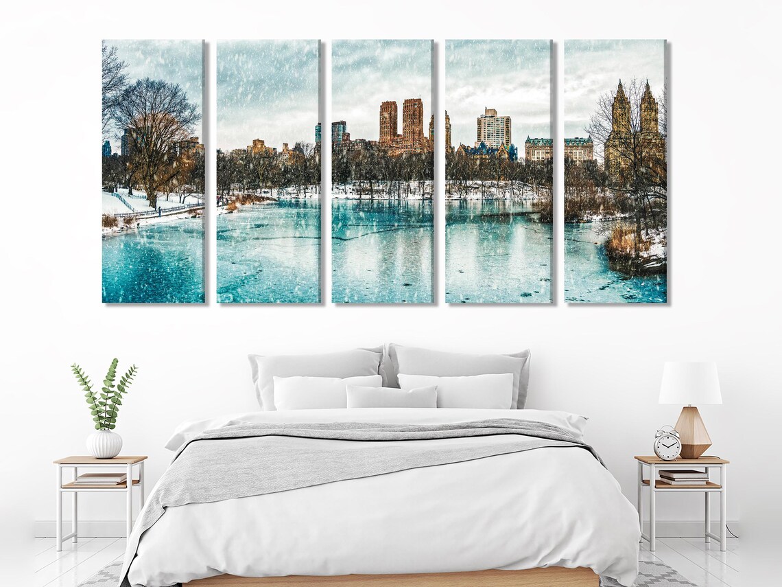 Three winter city skyline artworks displayed above a table in a living room mockup