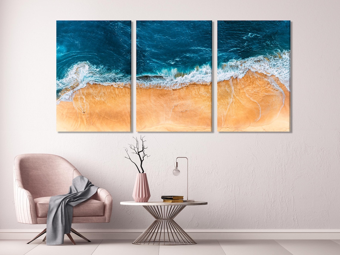 Seascape wall mockup showing five vertical ocean wave artworks above a kitchen table with chairs