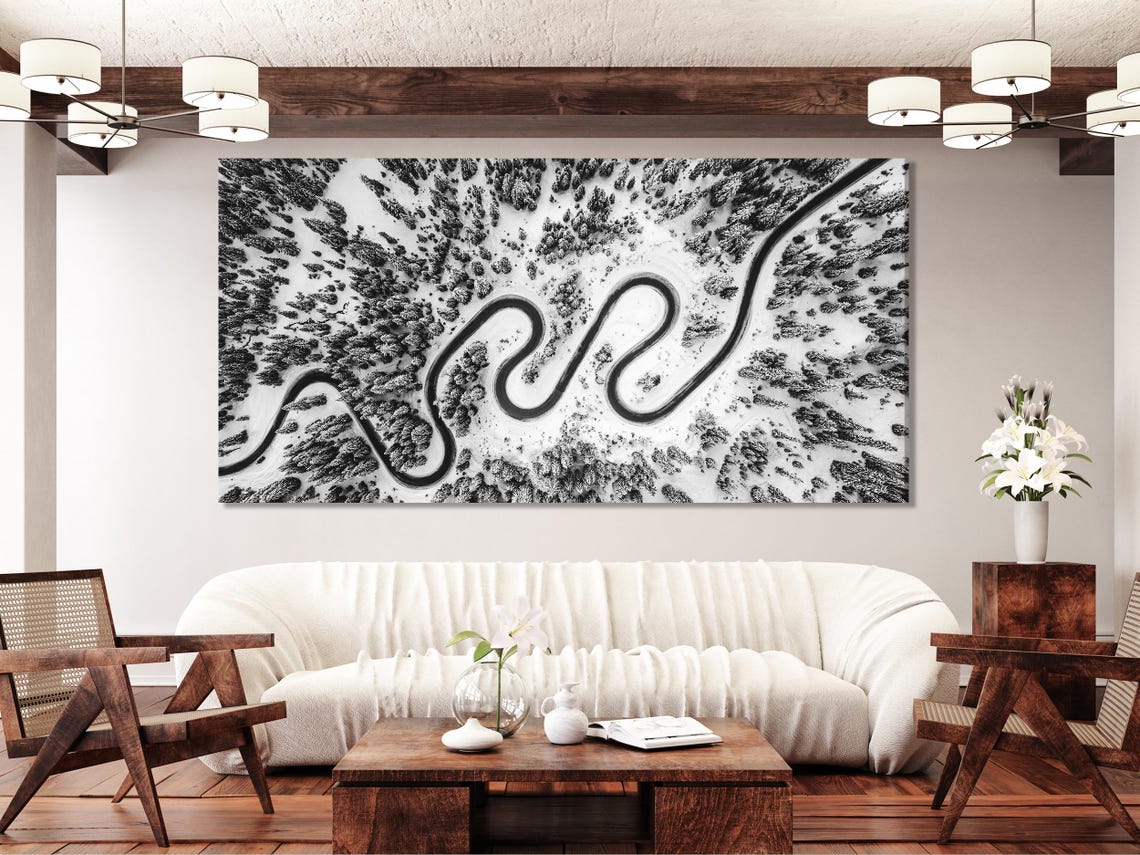 Three black-and-white aerial panels showing winding snowy roads through a forest detail view