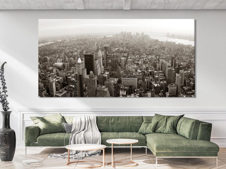 Monochrome aerial city skyline with dense skyscrapers and a river haze