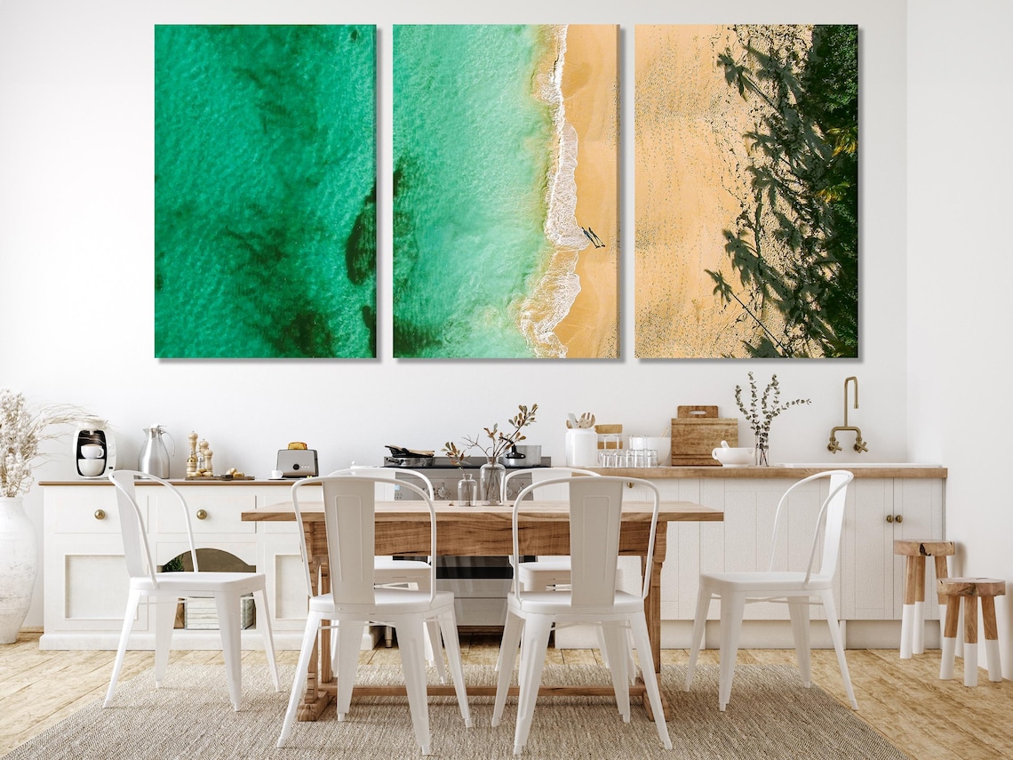Living room scene with an ocean beach artwork above a sofa and coffee table