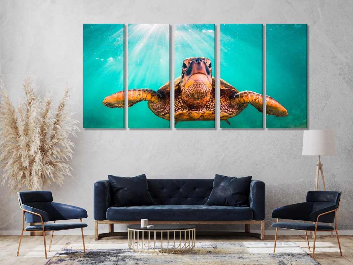 Underwater sea turtle swimming in turquoise water with diagonal sunrays detail view