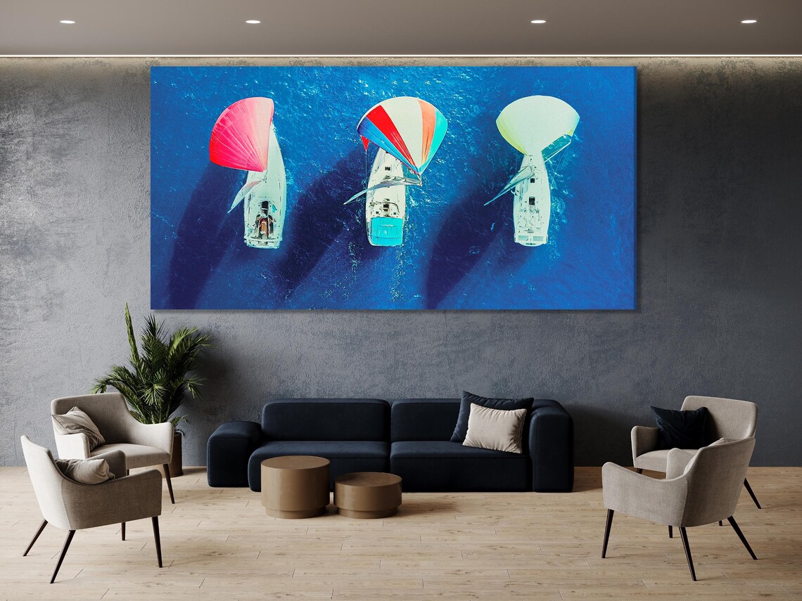 Aerial triptych of sailboats on deep blue ocean with bright red and pale green spinnaker sails detail view