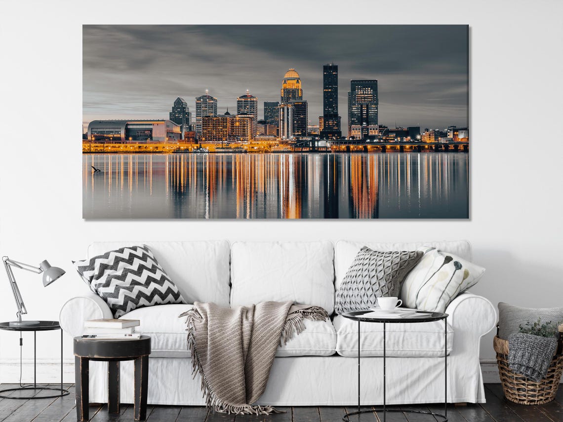 Room mockup with a multi-panel night skyline artwork above a bed and seating area