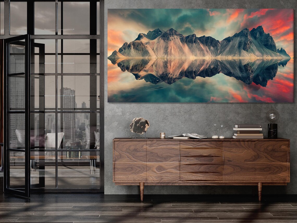 Wall mockup showing a split mountain sunset artwork above a sofa in a bright room
