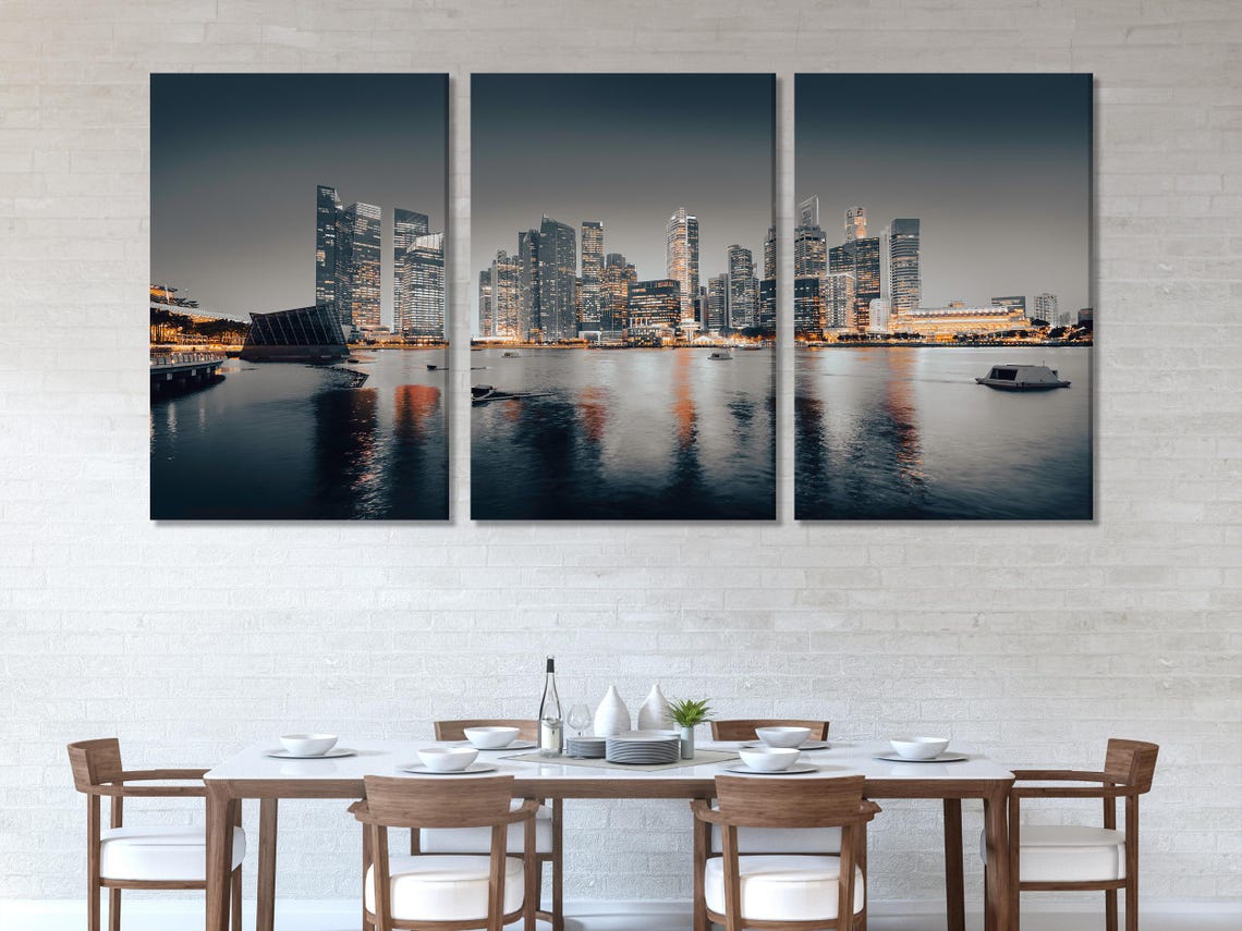 Living room mockup showing five-panel night city skyline artwork above a sofa