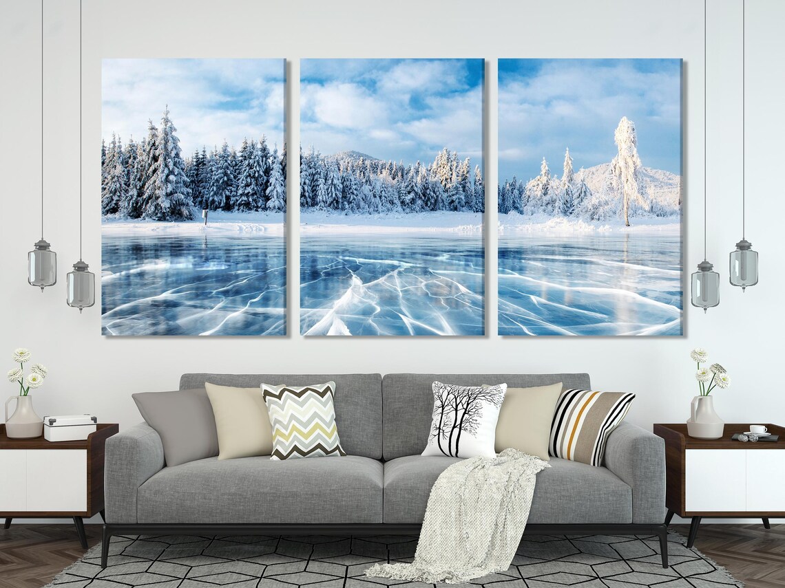 Room mockup showing a large winter frozen lake landscape artwork above a sofa