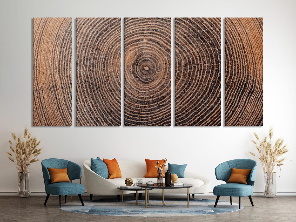 Three square panels show concentric tree-ring patterns radiating from darker centres, set within textured wood-grain lines in warm browns and black
