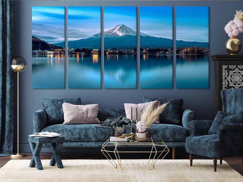 May include: A five-panel canvas print depicting a scenic view of Mount Fuji reflected in a still lake. The mountain is snow-capped and the sky is a soft blue with clouds. The lake is a deep blue and the surrounding landscape is green.