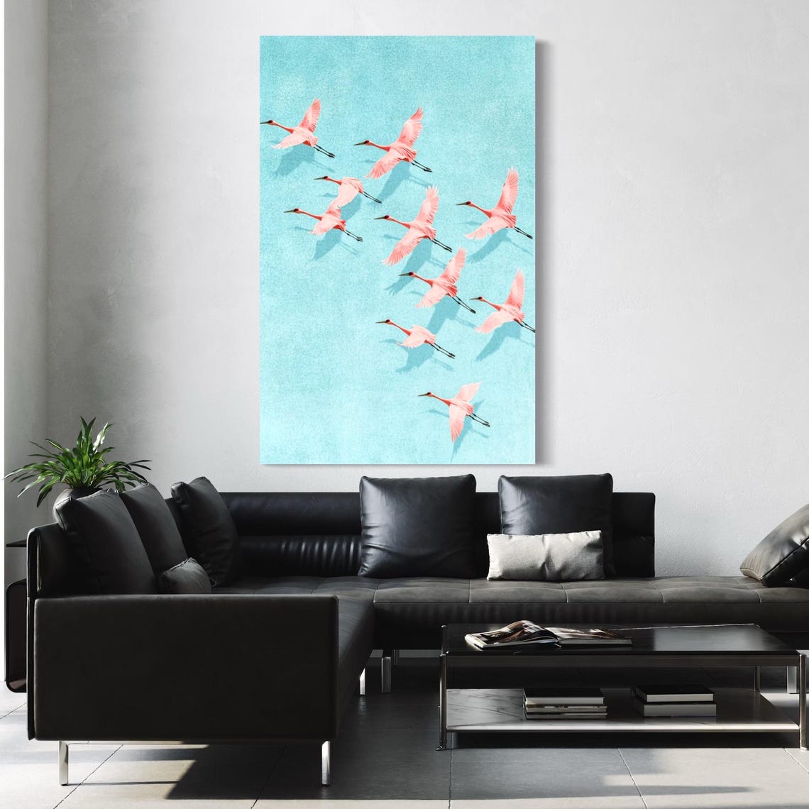 Pink cranes birds artwork shown above a white sofa in a bright living room