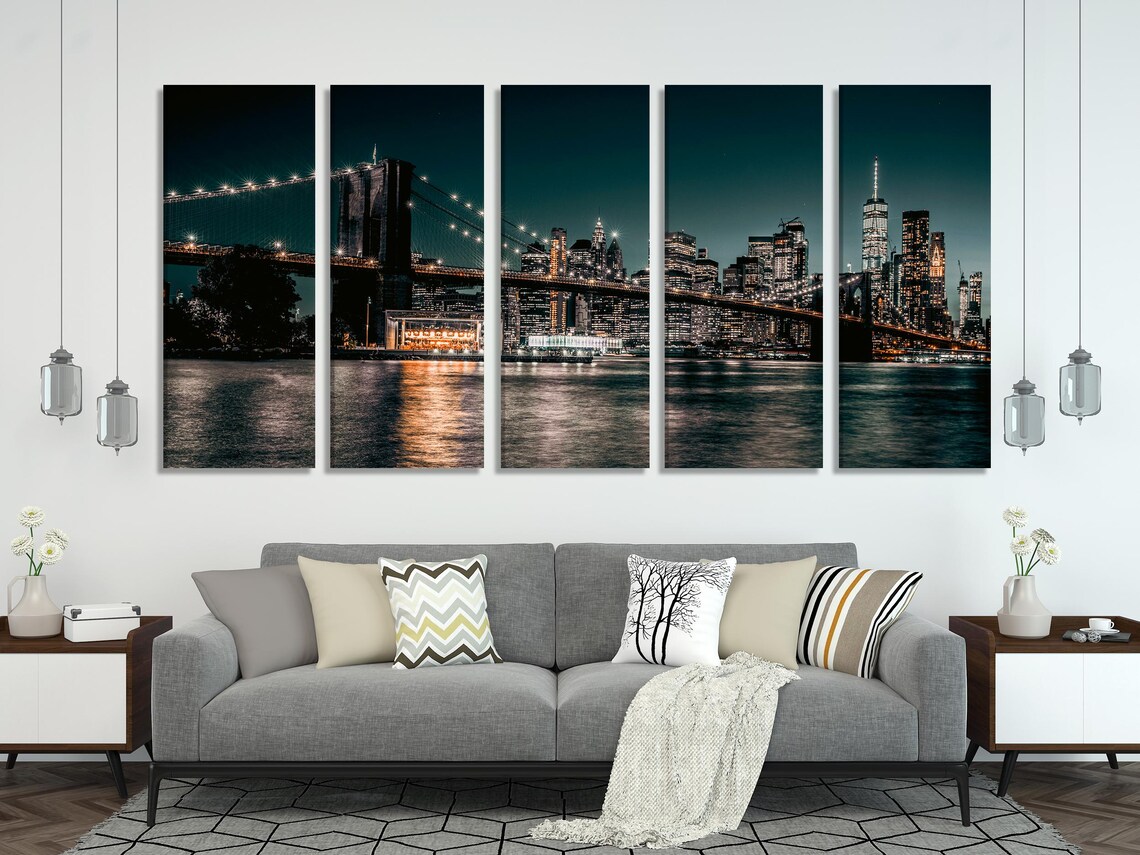 Night cityscape artwork above a white sofa in a modern living room