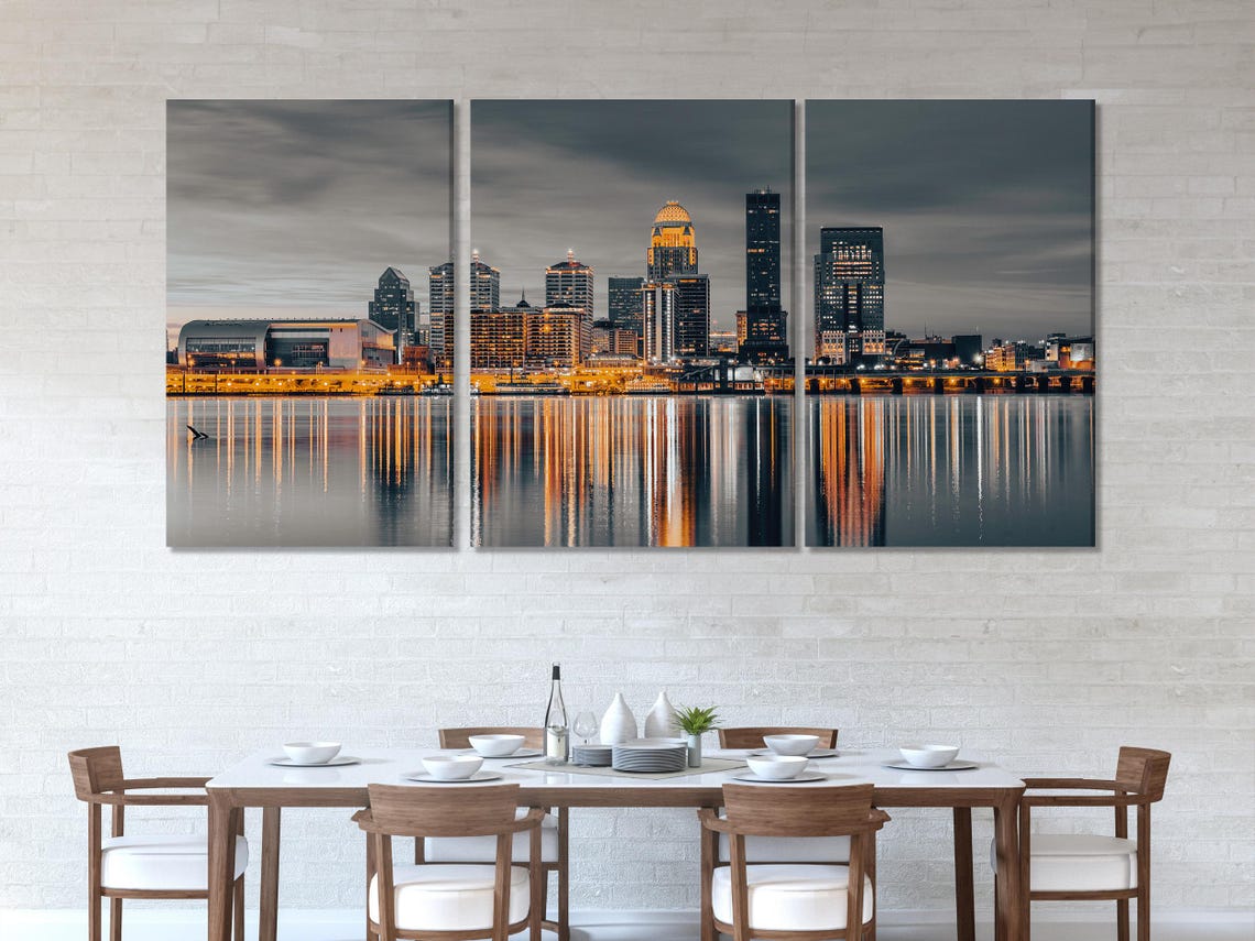 Room mockup with a multi-panel night skyline artwork above a bed and seating area