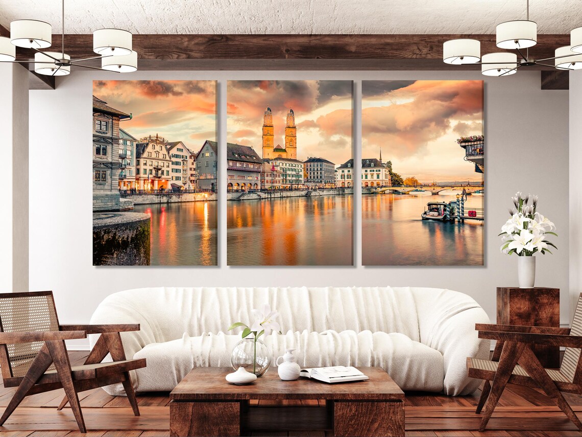 Dining area with wall-hung cityscape artwork featuring a twin-tower church at sunset