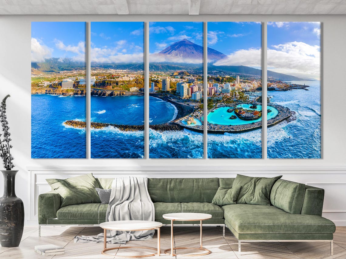 Room mockup showing three-panel aerial coastline artwork above a blue sofa