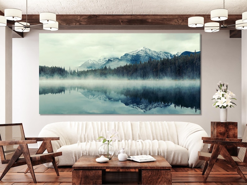 Misty mountain lake landscape with foggy pine forest and reflected peaks