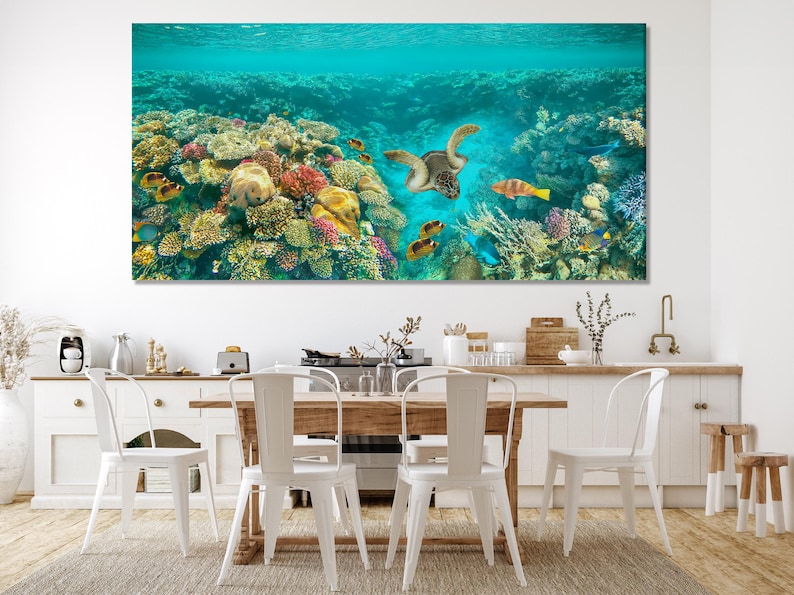 Underwater coral reef scene with a sea turtle swimming among tropical fish in turquoise water
