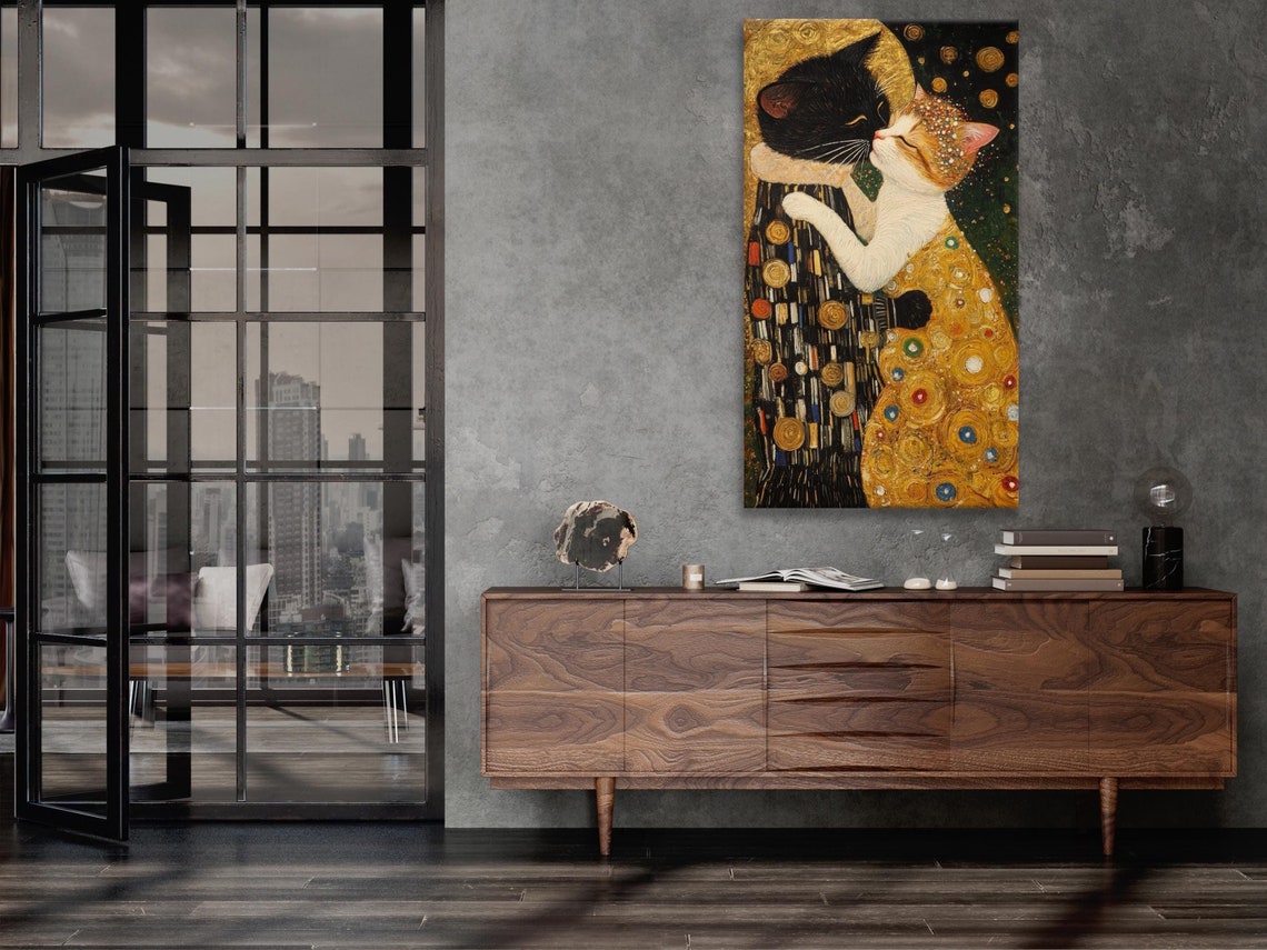 Cat kiss artwork hanging on a wall in a bright room with white chairs and a table