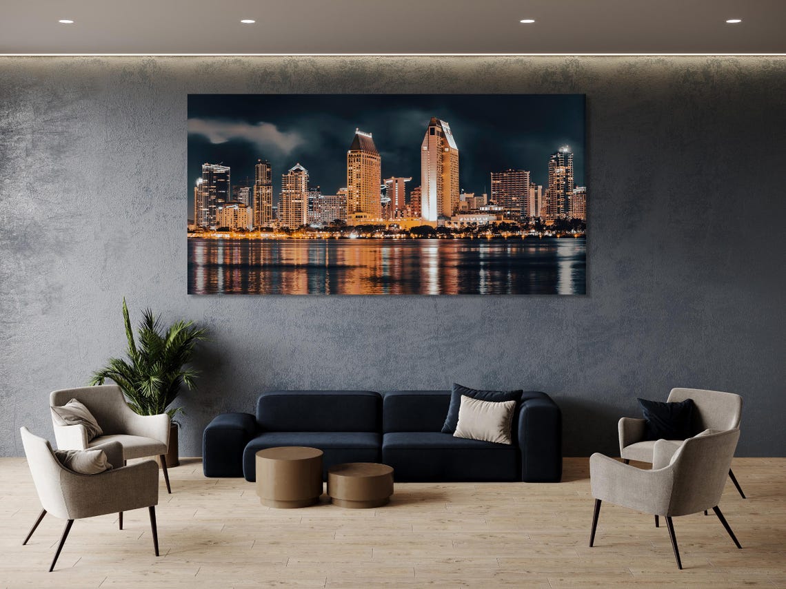 Mockup showing a modern living room with a multi-panel night city skyline artwork above the sofa