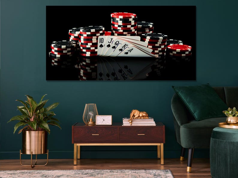 Poker chips stacked with playing cards in a dark, high-contrast casino scene