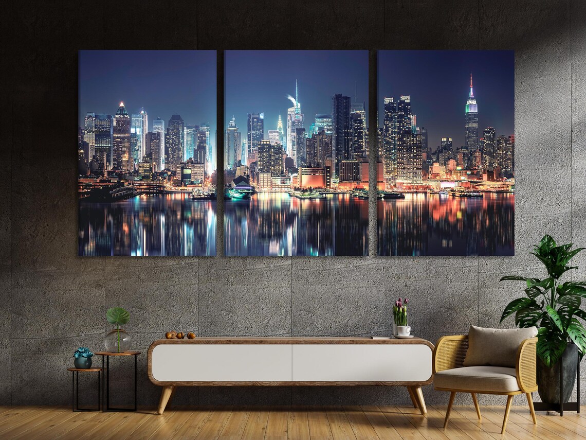 Room mockup showing a set of vertical night skyline artworks above a sofa
